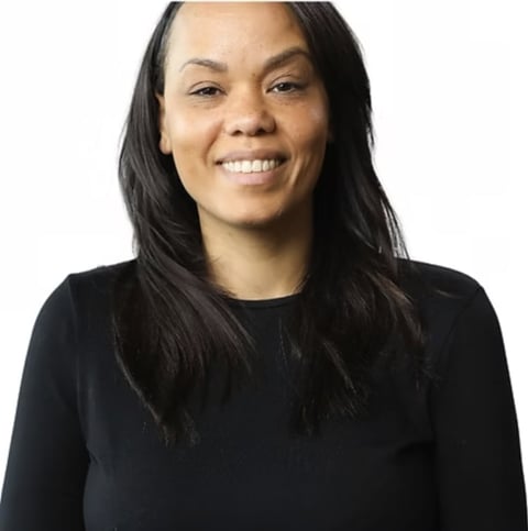 Smiling woman with long black hair wearing a black long-sleeved shirt, portrait photo against a white background