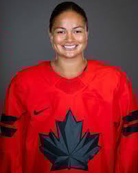 Woman in red Canadian hockey jersey with maple leaf logo smiling at camera against gray background